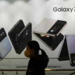 
              A woman passes by an advertisement of Samsung Electronics' Galaxy Z Flip4 at its shop in Seoul, South Korea, Tuesday, Jan. 31, 2023. Samsung Electronics said Tuesday its profit for the last quarter plummeted nearly 70% as a weak global economy depressed demands for its consumer electronics products and computer memory chips. (AP Photo/Ahn Young-joon)
            