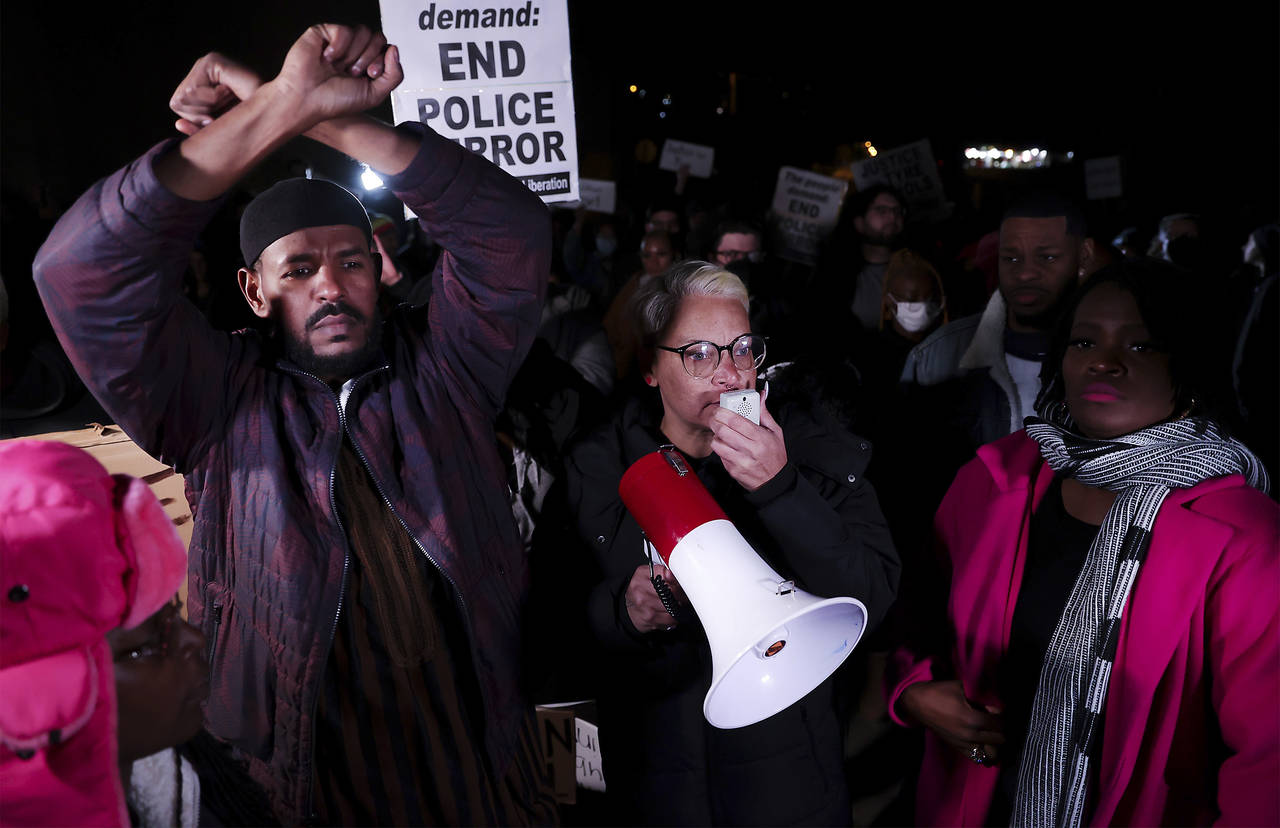 Protesters over the death of Tyre Nichols lead chants of "Hands up, don't shoot" while blocking tra...
