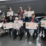 
              World War II veteran Joseph Eskenazi, who at 104 years and 11 months old is the oldest living veteran to survive the attack on Pearl Harbor, sits with fellow veterans and his great grandchildren Mathias, 4, and Audrey, 1, at an event celebrating his upcoming 105th birthday at the National World War II Museum in New Orleans, Wednesday, Jan. 11, 2023. (AP Photo/Gerald Herbert)
            