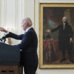 
              FILE - President Joe Biden calls on reporters for questions while speaking about the Russian invasion of Ukraine in the East Room of the White House, Feb. 24, 2022, in Washington. A portrait of former President George Washington is in the background. (AP Photo/Alex Brandon, File)
            