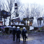
              Police officers stand inside a camp of climate activists at the village Luetzerath, near Erkelenz, Germany, Thursday, Jan. 12, 2023. Police have entered the condemned village in to evict the climate activists holed up at the site in an effort to prevent its demolition, to make way for the expansion of a coal mine. (AP Photo/Michael Probst)
            