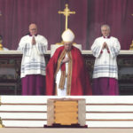 
              Pope Francis, centre, sits by the coffin of late Pope Emeritus Benedict XVI St. Peter's Square during a funeral mass at the Vatican, Thursday, Jan. 5, 2023. Benedict died at 95 on Dec. 31 in the monastery on the Vatican grounds where he had spent nearly all of his decade in retirement. (AP Photo/Antonio Calanni)
            