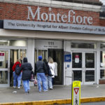 
              FILE - Medical workers enter Montefiore Medical Center during the coronavirus pandemic, Friday, April 24, 2020, in the Bronx borough of New York. Negotiations to keep 10,000 New York City nurses from walking off the job headed Friday, Jna. 6, 2023, into a final weekend as some major hospitals braced for a potential strike by sending ambulances elsewhere and transferring such patients as vulnerable newborns.  (AP Photo/John Minchillo, File)
            