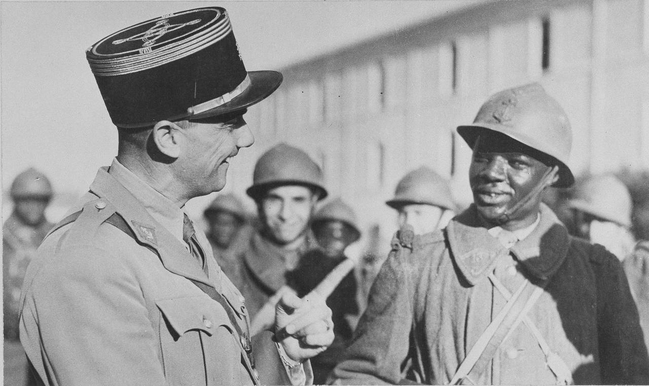 FILE - A French officer speaks to a Senegalese French Colonial soldier who has joined the Allies in...