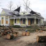 
              Remnants of downed trees lie in front of a damaged house in Selma, Ala., Friday, Jan. 13, 2023, after a tornado passed through the area. Rescuers raced Friday to find survivors in the aftermath of a tornado-spawning storm system that barreled across parts of Georgia and Alabama. (AP Photo/Stew Milne)
            