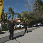 
              FILE - Police block the street to a house where three people were killed and four others wounded in a shooing at a short-term rental home in an upscale Los Angeles neighborhood on Saturday Jan. 28, 2023. The shooting occurred about 2:30 a.m. in the Beverly Crest neighborhood. (AP Photo/Richard Vogel, File)
            