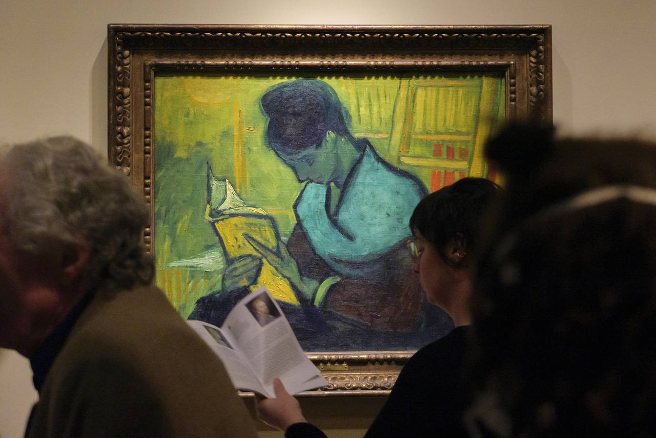 Visitors file past at the Van Gogh painting "Une Liseuse De Romans", also known as "The Novel Reade...