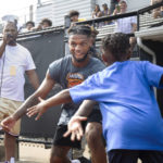 
              FILE - Buffalo Bills' Damar Hamlin high fives his little brother Damir Hamlin, 7, during a celebrity kickball game with all proceeds going to the Pittsburgh Promise scholarship fund which provides college tuition to local high school graduates, at George Cupples Stadium in Pittsburgh, Saturday, June 25, 2022. Damar Hamlin plans to support young people through education and sports with the $8.6 million in GoFundMe donations that unexpectedly poured into his toy drive fundraiser after he suffered a cardiac arrest in the middle of a game last week. (Maya Giron/Pittsburgh Post-Gazette via AP, File)
            
