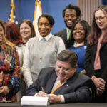 
              Illinois Gov. J.B. Pritzker signs House Bill 4664, a bill that will further protect reproductive health care providers and patients who are seeking care in Illinois, Friday, Jan. 13, 2023, in Chicago. (Pat Nabong/Chicago Sun-Times via AP)
            