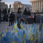 
              A woman stops to look at Ukrainian flags placed in memory of those killed during the war near Maidan Square in central Kyiv, Ukraine, Friday, Jan. 20, 2023. (AP Photo/Daniel Cole)
            