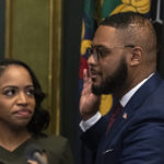 
              Austin Davis accompanied by his wife Blayre Holmes Davis takes the oath of office to become Pennsylvania's first Black lieutenant governor, during a ceremony Tuesday, Jan. 17, 2023, at the state Capitol in Harrisburg, Pa. (AP Photo/Matt Rourke)
            