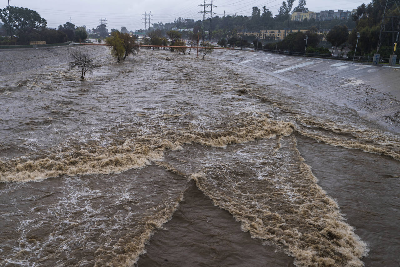 FILE - The Los Angeles River flows downstream in Los Angeles, Jan. 14, 2023. In Los Angeles, a comp...