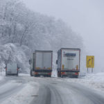 
              Trucks drive on a snow covered road in Kocevje, near Ljubljana Slovenia, Monday, Sept. 23, 2023. A snow storm with gust winds has hampered traffic on a key highway in Slovenia on Monday and left parts of the country temporarily without electricity. (AP Photo)
            