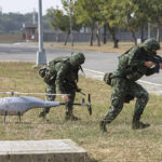 
              Soldiers deploy an unmanned aerial vehicle during a preparedness enhancement drill simulating the defense against Beijing's military intrusions, ahead of the Lunar New Year in Kaohsiung City, Taiwan on Wednesday, Jan 11, 2023. The drill is staged by the Taiwanese Defense Ministry amid growing tensions with China, which has significantly increased the presence of its People's Liberation Army near the self-governing island. (AP Photo/Daniel Ceng)
            