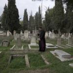 
              Hosam Naoum, a Palestinian Anglican bishop, walks where vandals desecrated more than 30 graves at a historic Protestant Cemetery on Jerusalem's Mount Zion in Jerusalem, Wednesday, Jan. 4, 2023. Israel's foreign ministry called the attack an "immoral act" and "an affront to religion." Police officers were sent to investigate the profanation. (AP Photo/ Mahmoud Illean)
            