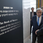 
              Antonio Guterres, United Nations Secretary General, center, and Dani Dayan, Chairman of Yad Vashem, far right, browse the Yad Vashem Book of Names of Holocaust Victims Exhibit, Thursday, Jan. 26, 2023, at United Nations headquarters. (AP Photo/John Minchillo)
            