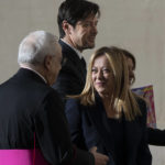 
              Italian Premier Giorgia Meloni, center, talks to Monsignor Leonardo Sapienza, left, as she arrives with her partner Andrea Giambruno, second from left, and her sister Arianna (partially hidden) at The Vatican, Tuesday, Jan. 10, 2023 for an audience with Pope Francis. (AP Photo/Domenico Stinellis)
            