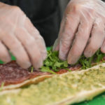 
              Chef Josh Gjersand prepares a sandwich with homemade pesto aioli and layered with Toscano salami, Monterey Jack and fresh arugula for Mount Diablo High School students to try during a taste test in Concord, Calif., Friday, Jan. 13, 2023. (AP Photo/Godofredo A. Vásquez)
            