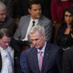 
              Rep. Kevin McCarthy, R-Calif., walks back to his seat after speaking with Rep. Matt Gaetz, R-Fla., after Gaetz voted "present" in the House chamber as the House meets for the fourth day to elect a speaker and convene the 118th Congress in Washington, Friday, Jan. 6, 2023. (AP Photo/Alex Brandon)
            