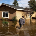 
              Nick Enero wades through floodwaters while helping his brother salvage items from his Merced, Calif., home as storms continue battering the state on Jan. 10, 2023. The series of storms that have struck California have poured water on a state mired in a years-long drought. Experts say the precipitation will help relieve the drought somewhat.  (AP Photo/Noah Berger)
            