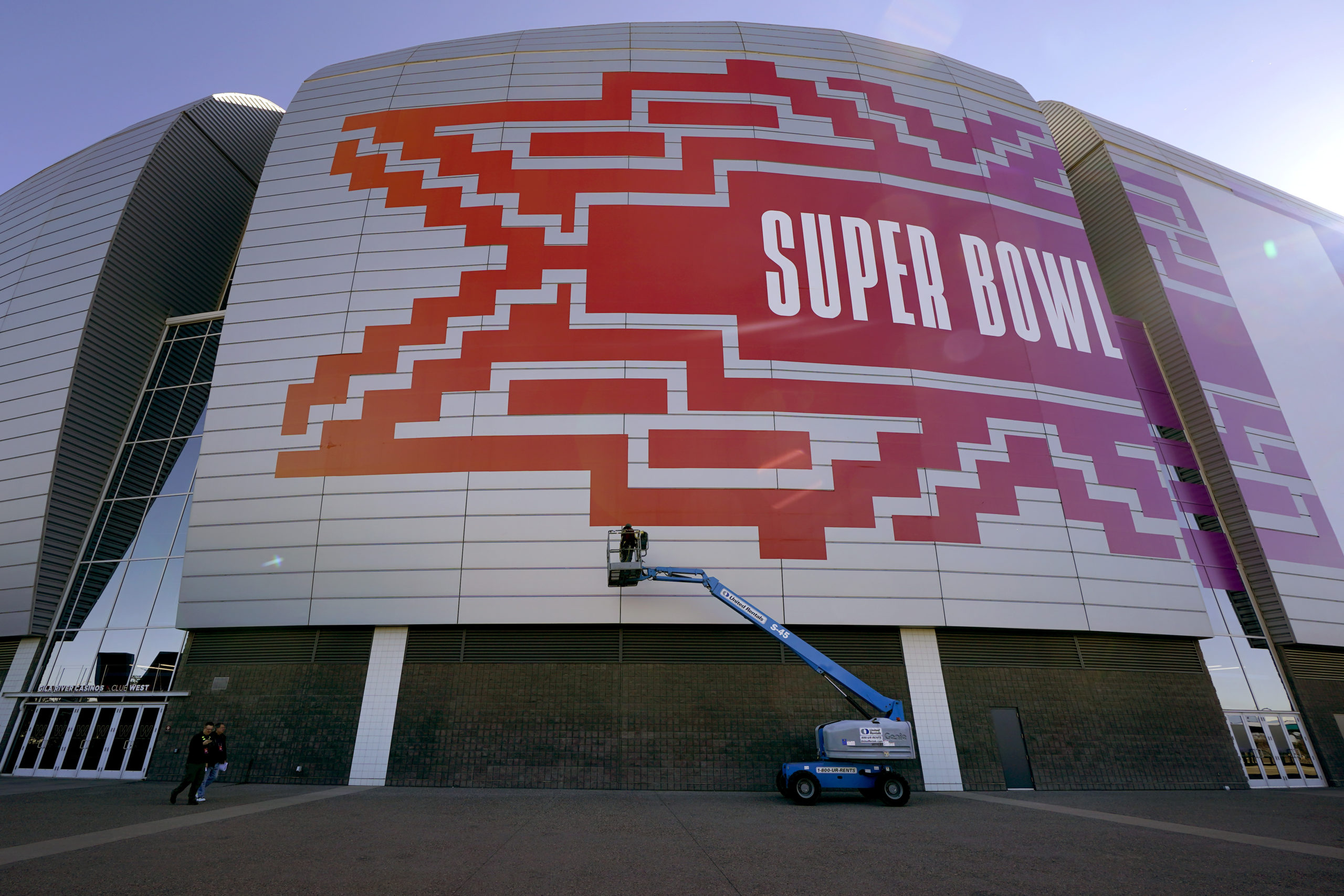 Workers prepare for the NFL Super Bowl LVII football game outside State Farm Stadium, Wednesday, Fe...