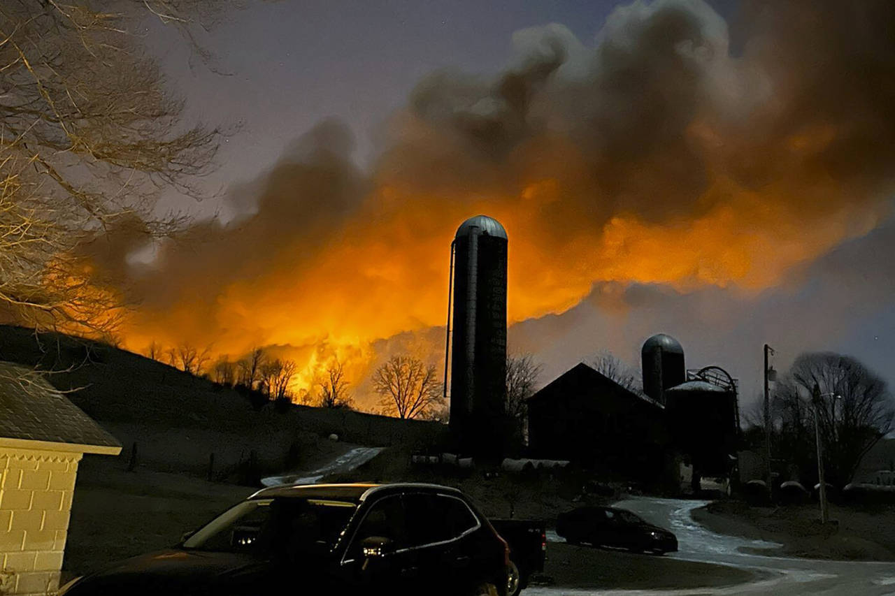 In this photo provided by Melissa Smith, a train fire is seen from her farm in East Palestine, Ohio...