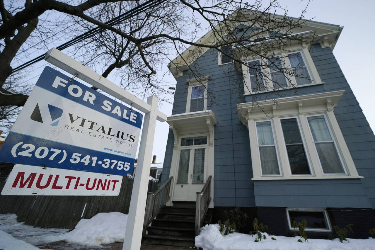 A sign announces a home for sale on Munjoy Hill, Wednesday, Jan. 25, 2023, in Portland, Maine. On T...