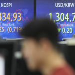 
              A currency trader watches computer monitors near the screens showing the Korea Composite Stock Price Index (KOSPI), left, and the foreign exchange rate between U.S. dollar and South Korean won at a foreign exchange dealing room in Seoul, South Korea, Thursday, Feb. 23, 2023. Asian stock markets rose Thursday following Wall Street's biggest one-day decline in two months after notes from a Federal Reserve meeting showed officials expect to keep U.S. interest rates high to fight stubborn inflation. (AP Photo/Lee Jin-man)
            