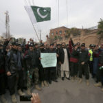 
              Police officers chant slogans as they take part in a peace march organized by a civil society group denouncing militant attacks and demanding peace in the country, in Peshawar, Pakistan, Wednesday, Feb. 1, 2023. The placard is center in Urdu language reading as 'Why is the blood of KP police so cheap?'. (AP Photo/Muhammad Sajjad)
            