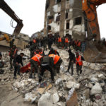 
              Civil defense workers and security forces search through the wreckage of collapsed buildings in Hama, Syria, Monday, Feb. 6, 2023. A powerful earthquake has caused significant damage in southeast Turkey and Syria and many casualties are feared. Damage was reported across several Turkish provinces, and rescue teams were being sent from around the country. (AP Photo/Omar Sanadik)
            