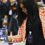
              A visitor checks a Xiaomi 13 mobile phone model at the Xiaomi booth before the Mobile World Congress 2023 in Barcelona, Spain, on Sunday, Feb. 26, 2023. The four-day show, also known as Mobile World Congress, kicks off Monday in a vast Barcelona conference center. It's the world's biggest and most influential meeting for the mobile tech industry. (AP Photo/Joan Monfort)
            