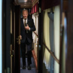 
              President Joe Biden walks down a corridor to his cabin on a train after a surprise visit with Ukrainian President Volodymyr Zelenskyy, Monday, Feb. 20, 2023, in Kyiv. Biden took a nearly 10-hour train ride from Poland into Kyiv. (AP Photo/Evan Vucci, Pool)
            