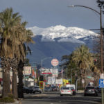 
              Snow-capped Mount Hamilton rises above San Jose, Calif. in a view down West San Carlos Street, Friday, Feb. 24, 2023. (Karl Mondon /Bay Area News Group via AP)
            