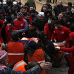 
              Civil defense workers and security forces carry an earthquake victim as they search through the wreckage of collapsed buildings in Hama, Syria, Monday, Feb. 6, 2023. A powerful earthquake has caused significant damage in southeast Turkey and Syria and many casualties are feared. Damage was reported across several Turkish provinces, and rescue teams were being sent from around the country. (AP Photo/Omar Sanadik)
            