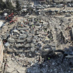 
              Aerial photo shows the destruction in Kahramanmaras city center, southern Turkey, Thursday, Feb. 9, 2023. Thousands who lost their homes in a catastrophic earthquake huddled around campfires and clamored for food and water in the bitter cold, three days after the temblor and series of aftershocks hit Turkey and Syria. (IHA via AP)
            