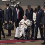 
              Pope Francis talks to South Sudan's President Salva Kiir, center-right, after arriving at the airport in Juba, South Sudan Friday, Feb. 3, 2023. Pope Francis arrived in South Sudan on the second leg of a six-day trip that started in Congo, hoping to bring comfort and encouragement to two countries that have been riven by poverty, conflicts and what he calls a "colonialist mentality" that has exploited Africa for centuries. (AP Photo/Ben Curtis)
            