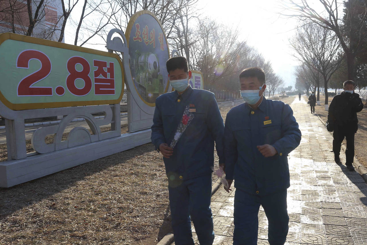 People walk on a street of Pothonggang District in Pyongyang, North Korea Wednesday, Feb. 8, 2023, ...