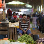 
              FILE - A vender waits for customers at a vegetable market place in Colombo, Sri Lanka, Friday, June 10, 2022. China’s government on Friday, Feb. 2, 2023, confirmed it is offering Sri Lanka a two-year moratorium on loan repayment as the Indian Ocean island nation struggles to restructure $51 billion in foreign debt that pushed it into a financial crisis. (AP Photo/Eranga Jayawardena)
            