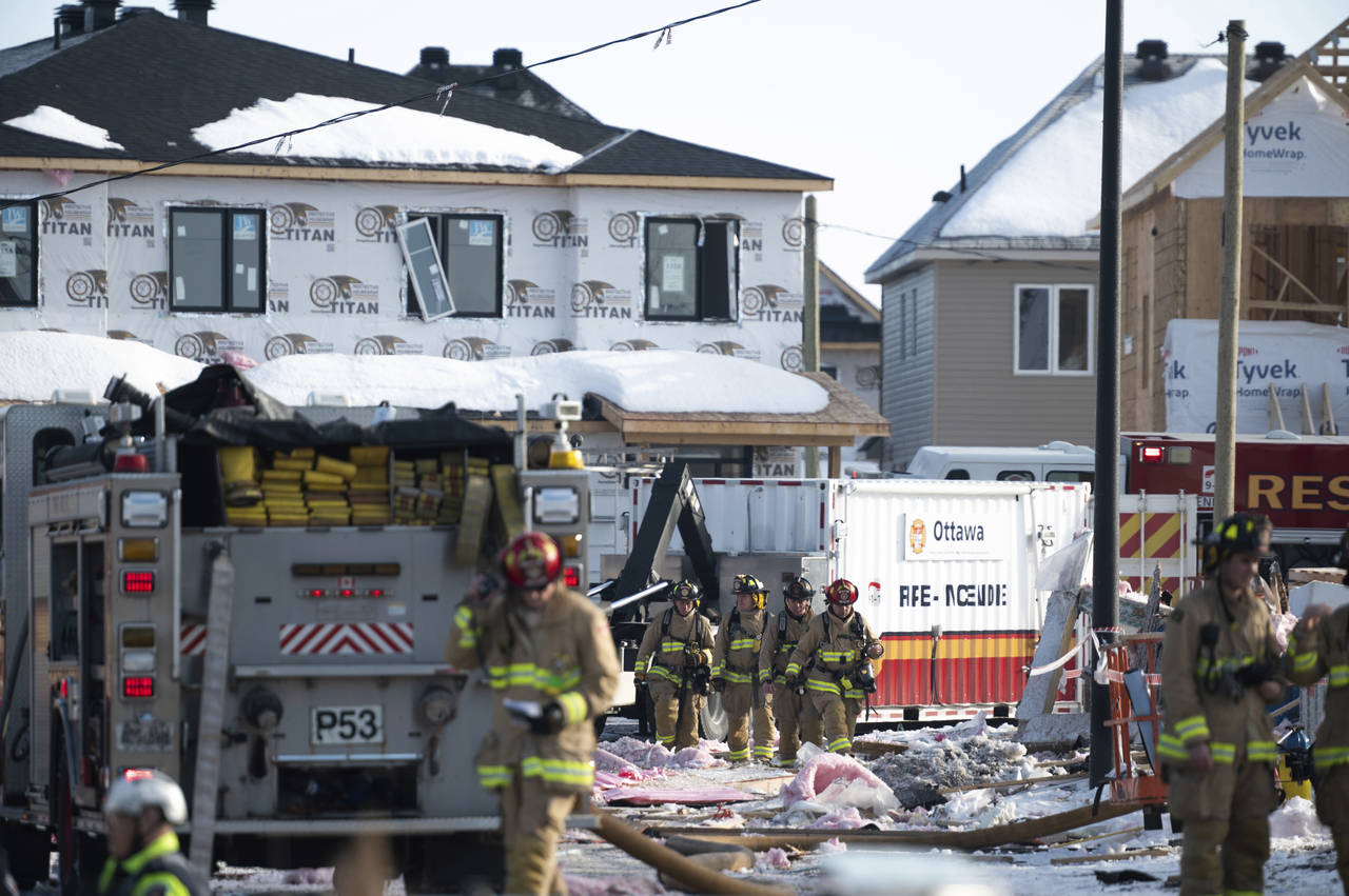 Firefighters from the Ottawa Fire Service work the scene of an early morning gas leak explosion in ...