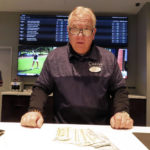 
              Frank Caltagirone, a sports book employee at the Ocean Casino Resort in Atlantic City, N.J., counts money from his drawer Monday, Feb. 6, 2023. On Feb. 7, 2023, the gambling industry's national trade group, the American Gaming Association, predicted that over 50 million American adults will bet a total of $16 billion on this year's Super Bowl, including legal bets with sports books, illegal ones with bookies, and casual bets among friends or relatives. (AP Photo/Wayne Parry)
            