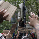 
              FILE - Protesters raise their hands near Foley Square, June 2, 2020, in New York, as part of a demonstration against police brutality sparked by the death of George Floyd, a Black man who died earlier that year after Minneapolis police officers restrained him.  The death of Tyre Nichols in Memphis stands apart from some other police killings because the young Black man was beaten by Black officers. But the fact that Black officers killed a Black man didn’t remove racism from the situation. (AP Photo/Yuki Iwamura, File)
            