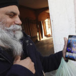 
              Swaranjit Singh Ghotra, photographer and wedding planner for Indian and Pakistani couples shows pictures of married couples from his Instagram account, in Brescia, Italy, Wednesday, Feb. 8, 2023. He said he receives many requests for arranged marriages that both spouses want. But courageous refusal by young immigrant women in Italy to submit to forced marriages sometimes carries a deadly price. In two murder trials this month, Italian prosecutors are seeking justice for Pakistani immigrant women allegedly killed because they refused marriages imposed by their parents. (AP Photo/Luca Bruno)
            