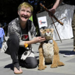 
              Robin Walsh smiles with a puppet of P-22 she designed and built during a celebration of life for the wild mountain lion known, who died late last year, at the Greek Theatre in Griffith Park in Los Angeles on Saturday, Feb. 4, 2023. (Keith Birmingham/The Orange County Register via AP)
            