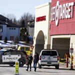 
              Customers and employees gathered so they can retrieve their belongings on Wednesday, Feb. 1, 2023, a day after they fled the Target store after someone walked in and started firing an assault rifle. Omaha police shot and killed the suspect. (Chris Machian/Omaha World-Herald via AP)
            