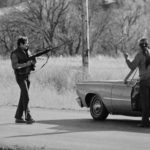 
              FILE - FBI agents stop a man at a roadblock near Wounded Knee, S.D., in 1973. (AP Photo/Jim Mone, File)
            