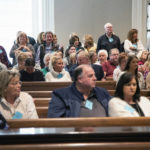 
              The audience stands to try and see Alex Murdaugh before his double murder trial at the Colleton County Courthouse on Wednesday, Feb. 8, 2023, in Walterboro, S.C. The 54-year-old attorney is standing trial on two counts of murder in the shootings of his wife and son at their Colleton County home and hunting lodge on June 7, 2021. (Joshua Boucher/The State via AP, Pool)
            
