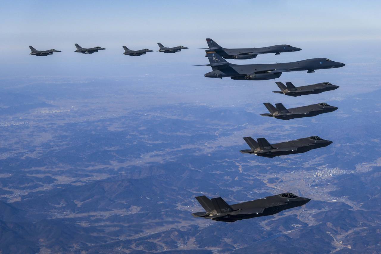 In this photo provided by South Korea Defense Ministry, U.S. Air Force B-1B bombers, center, fly in...