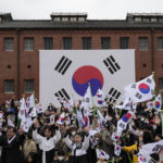 
              South Koreans give three cheers for the country during a ceremony to celebrate the March First Independence Movement Day, the anniversary of the 1919 uprising against Japanese colonial rule, in Seoul, South Korea, Wednesday, March 1, 2023. (AP Photo/Ahn Young-joon)
            