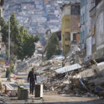 
              A man walks past destroyed buildings in Antakya, southeastern Turkey, Tuesday, Feb. 21, 2023. The death toll in Turkey and Syria rose to eight in a new and powerful earthquake that struck two weeks after a devastating temblor killed nearly 45,000 people, authorities and media said Tuesday. (AP Photo/Unal Cam)
            