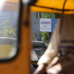 
              An autorickshaw driver waits for passengers in front of an Adani gas customer care centre in Ahmedabad, India, Feb. 2, 2023. Shares in Adani Enterprises tumbled 26% Thursday, while stock in six other Adani companies fell 5%-10%. Adani slid from being the world’s third richest man to the 13th as his fortune sank to $72 billion, according to Bloomberg’s Billionaire Index. (AP Photo/Ajit Solanki)
            